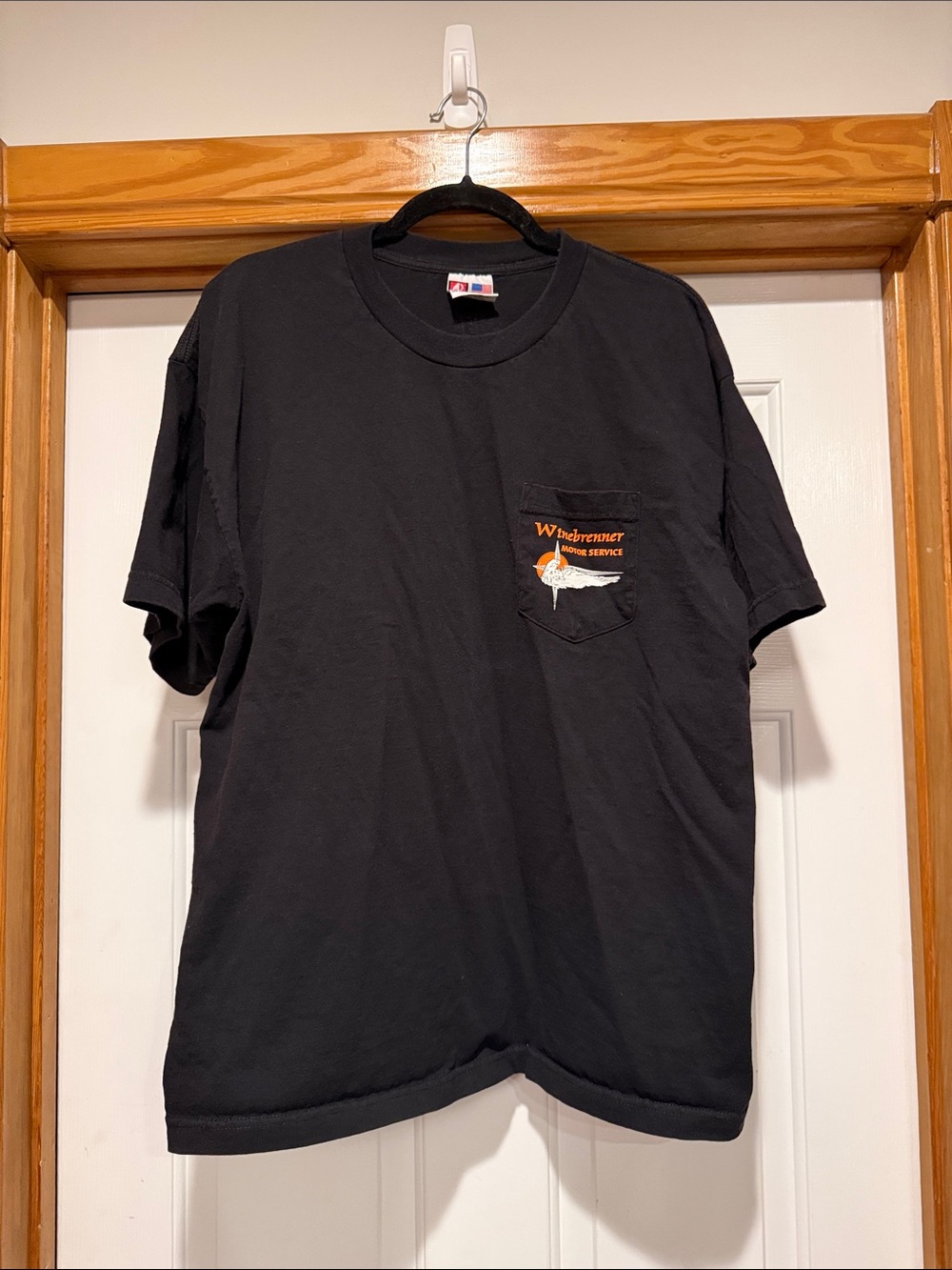 Black Short-Sleeve Pocket Tee with Orange Logo Detail